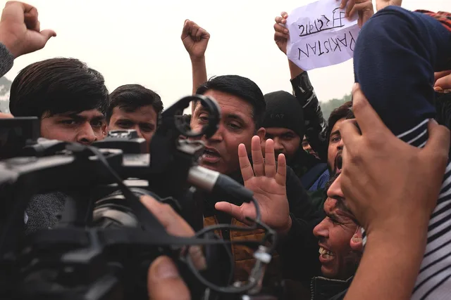 journalist, tv, reportage, media, news, camera, reporter, television, press, operator, equipment, video, woman, stream, microphone, human, crowd, india, strike, pakistan, people, developments, protesters. International conflict reporting problems and fixes