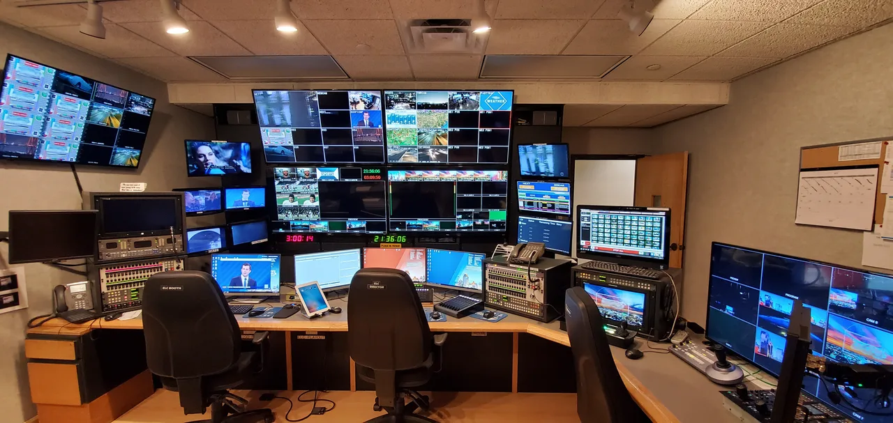 A television news control room with production screens and consoles