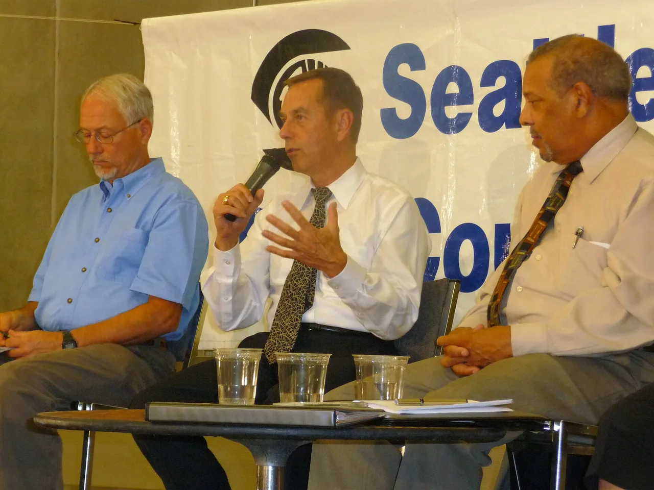 Officials speaking at a council public meeting