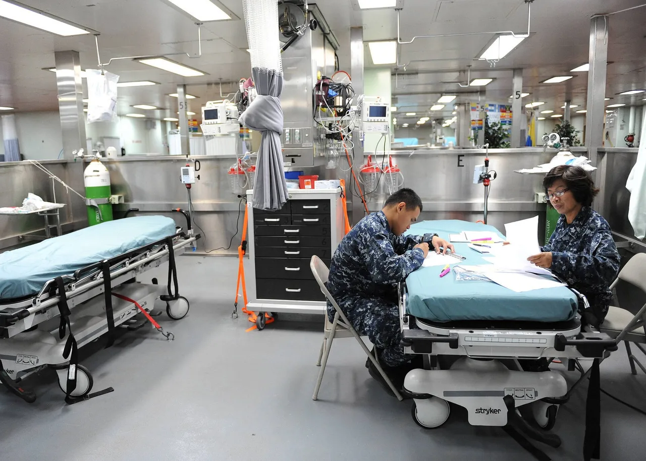 Two clinicians reviewing records in a hospital treatment area