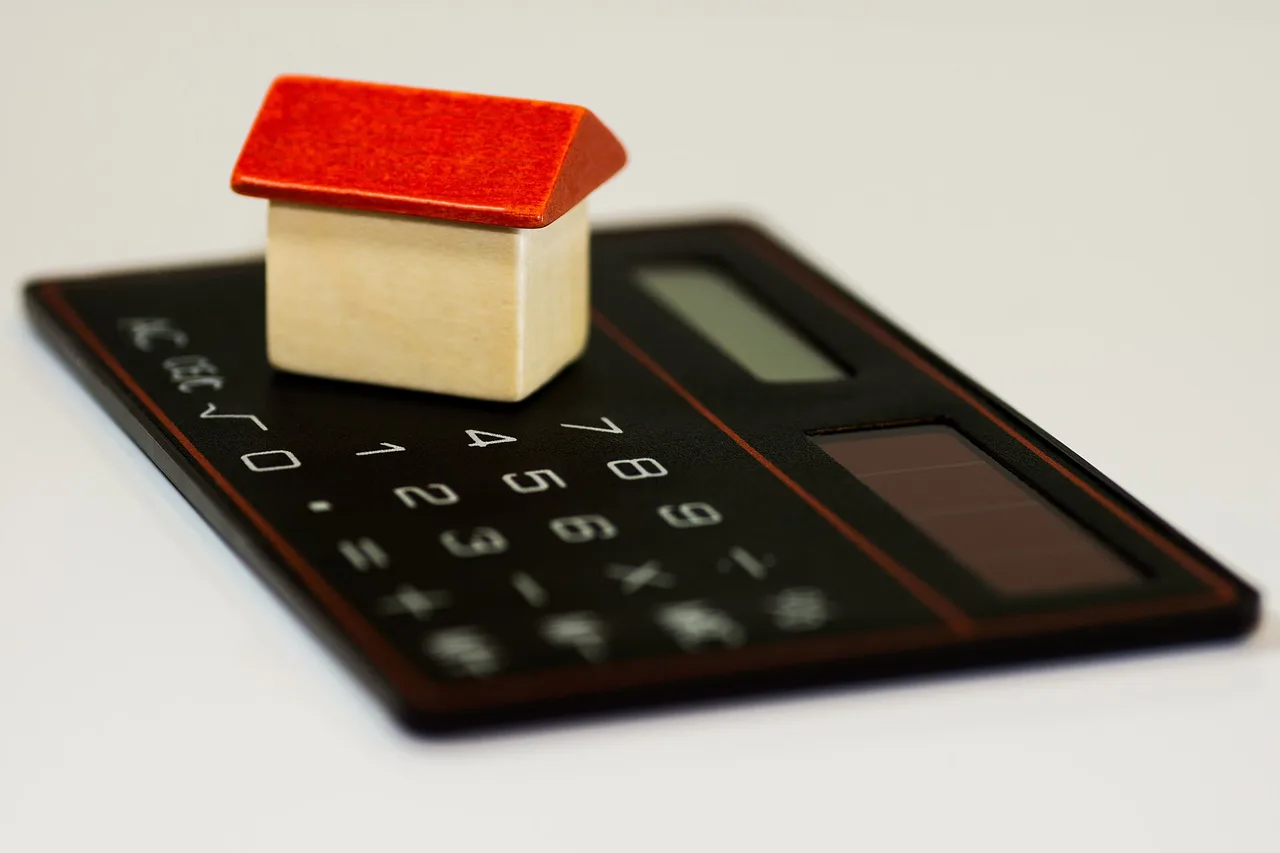 A model house resting on a calculator